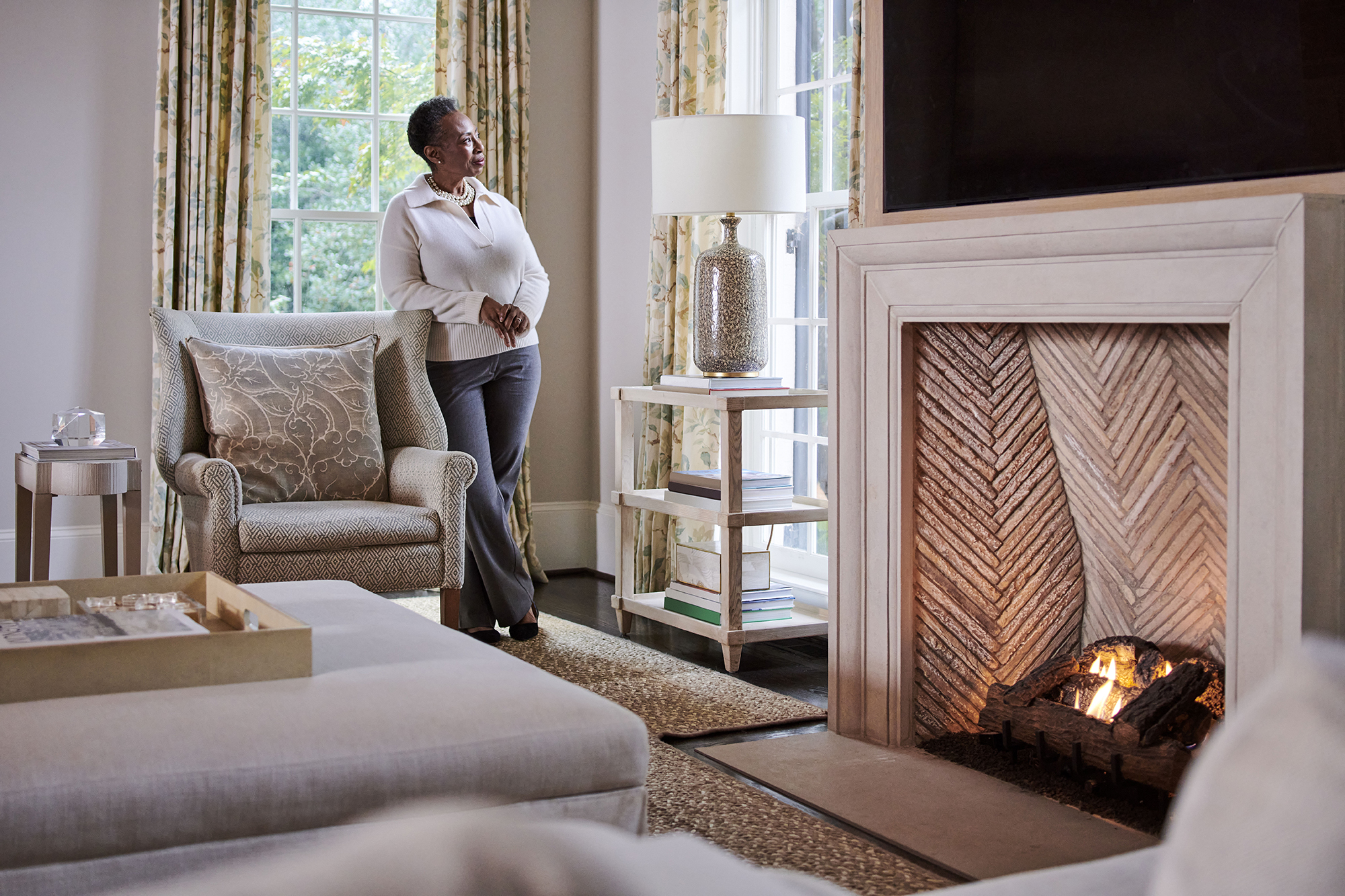 A woman appreciating and admiring the beautiful staging that was completed in her living room and patio.